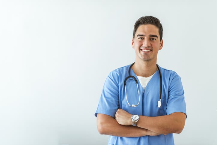 Young doctor smiling and standing for a picture